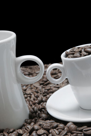 Coffee cups with coffee beans and a black backgroundの写真素材