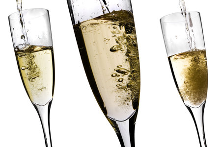 Champagne glasses with bubbling champagne flowing inの写真素材