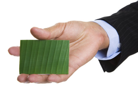 Man giving out a green business cardの写真素材