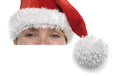 Woman in a santa hat with a sign in front of her with plenty of copyspaceの写真素材