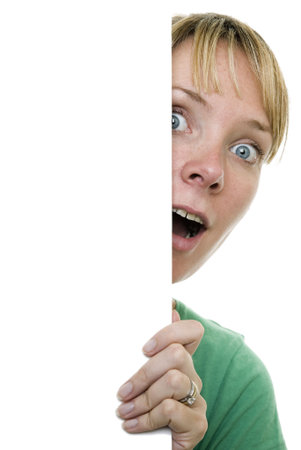 Woman standing behind white signの写真素材