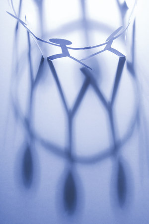 Little paper people with a long shadowの写真素材