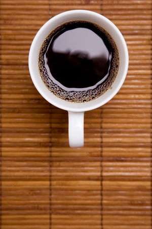 Cup of black coffee on a bamboo mat from aboveの写真素材