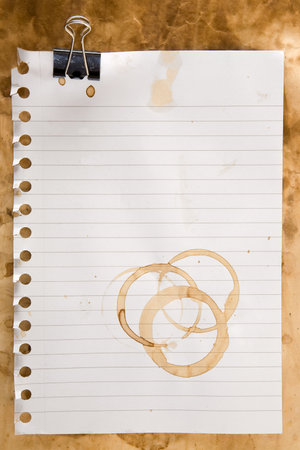 Paper from a notepad with coffee stains and clipの写真素材