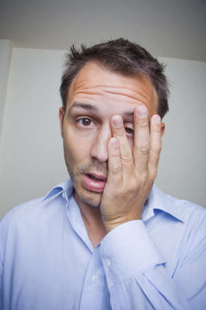 Tired business man rubbing his eyes. の写真素材