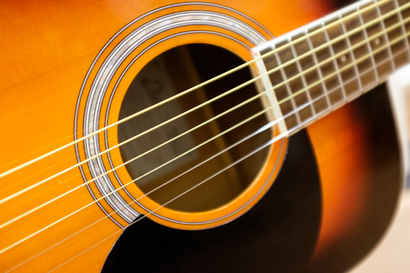 Detail of a wooden acoustic guitarの写真素材