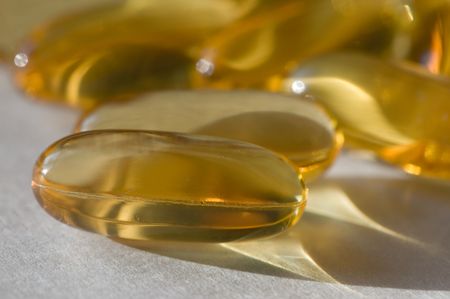 Close up of gold colored pillsの写真素材
