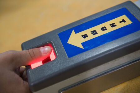 Taking thumbprint with digital scannerの写真素材