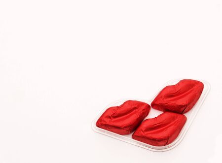 Lip-shaped chocolates wrapped in redの写真素材