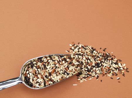 a metal scoop with a blend of wild, long grain and brown ricesの写真素材