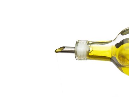 olive oil being poured from a glass bottle