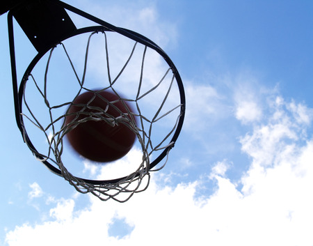 basketball going through an outdoor basketball hoop