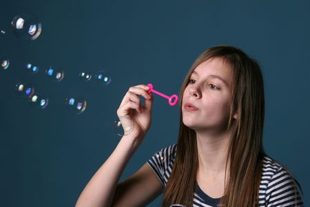 pretty teenage girl blowing bubbles