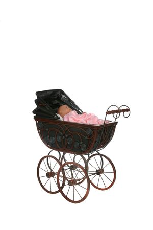 antique baby carriage with doll inisdeの写真素材