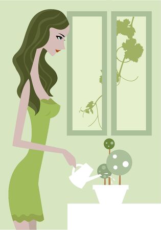 Side view of a woman in green dress watering a plantの写真素材