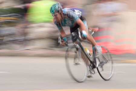 An intentional slow-shutter blur, gives this bike racer feeling of motion and intensity.  It also removes all the sponsors from his jersy (And we like that).の写真素材