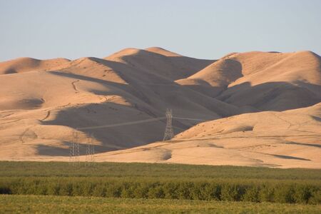 A California farm spreads out below some foothills of the central valley.の写真素材