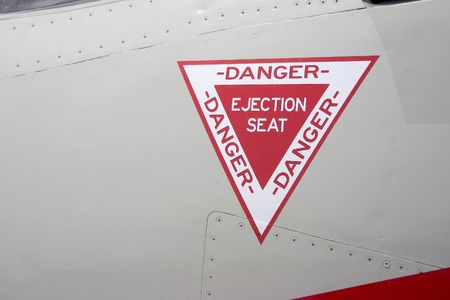 The ejection seat warning on the outside of a fighter jet.の写真素材