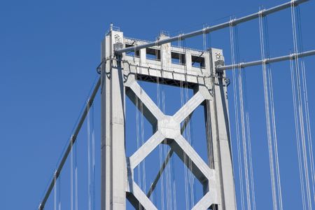 A tall tower of San Francisco's Bay Bridge rises into the sky.の写真素材