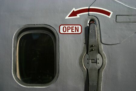 A closeup, of the exit door of a jet airliner.の写真素材