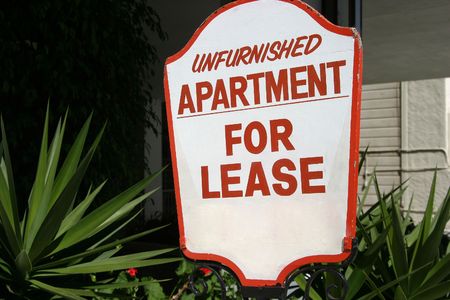 A sign advertising an unfurnished apartment for lease.の写真素材