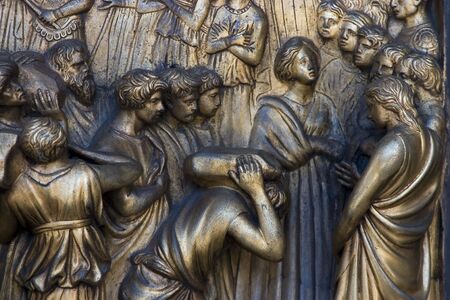 A religious icon on a brass church door.の写真素材