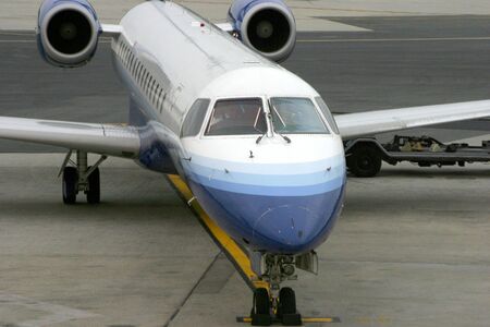 A commuter jet pulls up to the terminal at Newark international airport.