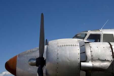 An old prop plane against a blue sky.の写真素材