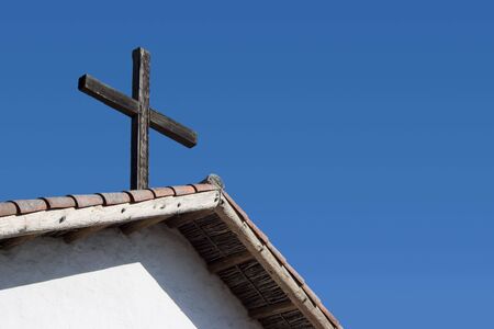 A cross on the roof of a California mission.の写真素材