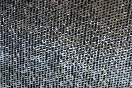 Lots of shimmering circles hanging on a wall.の写真素材