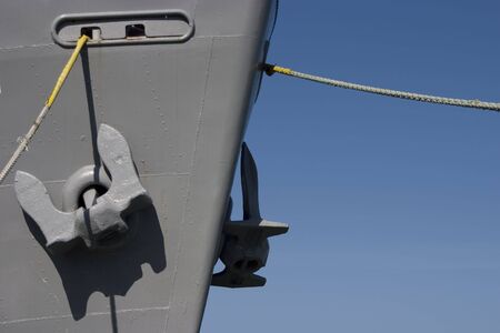 Giant Anchors hang from the bow of a ship.の写真素材