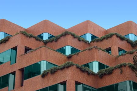 A modern brick building with terraces.の写真素材