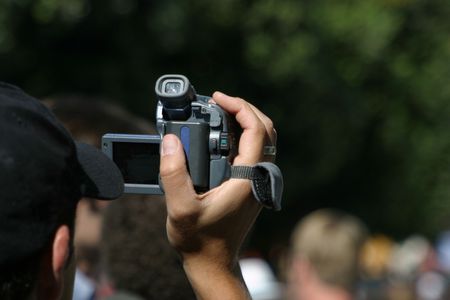 A man videotapes an event.
