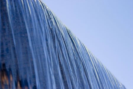 A waterfall fountain in a city park.の写真素材