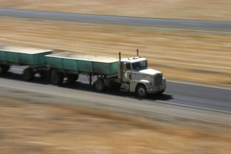 A tractor-trailer hauls some stuff down the highway.の写真素材