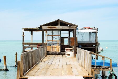 Fisherman's Cottage inside the sea at sunny dayの写真素材