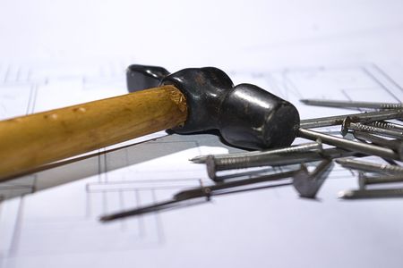 photo of the hammer and nails on the house planの写真素材