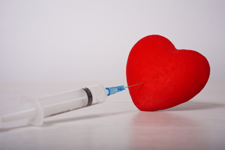 Syringe laid in the form of heartの写真素材