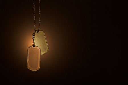Military ID tags on a dark backgroundの写真素材