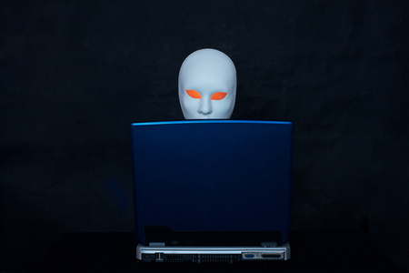 Concept of terrorism.Mask and laptop on darkの写真素材