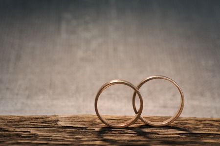 wedding rings on woodの写真素材