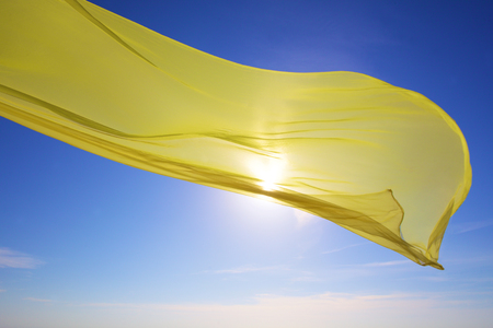 yellow tissue flying over the seaの写真素材