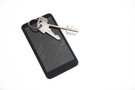 keys on black mobile phone with a broken screenの写真素材