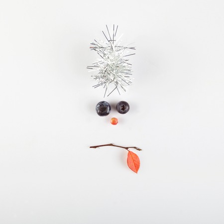 christmas face made of berries and tree branch.Minimal christmas concept.の写真素材