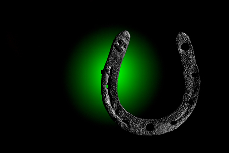 HorseShoe rusty steel on dark backgroundの写真素材