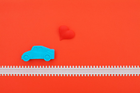 blue kinetic sand car and red heart on pink backgroundの写真素材