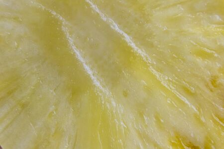 Ripe pineapple and pineapple slices on a wooden background tropical fruits.