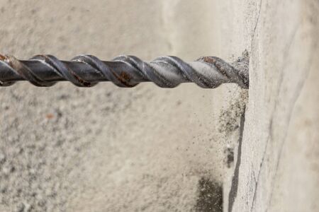 People are using electric drill,He drilled concrete to put steel anchor.の写真素材