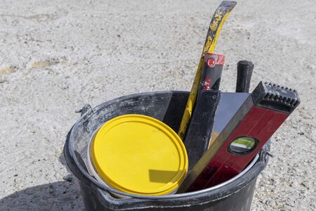 Image of construction tools in a bucket