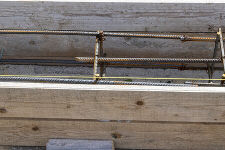 Foundation site of new house, building, details and reinforcements with steel bars and wire rod, preparing for cement pouringの写真素材